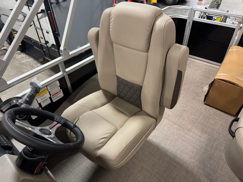 Slide: The Image of 2025 Sun Tracker Sportfish 24 XP3 captain's chair with steering wheel, beige upholstery. - 7
