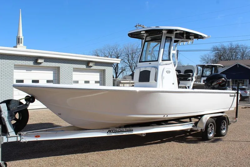 Slide: The Image of 2025 Tidewater 2410 BM boat on trailer, parked outdoors. - 1