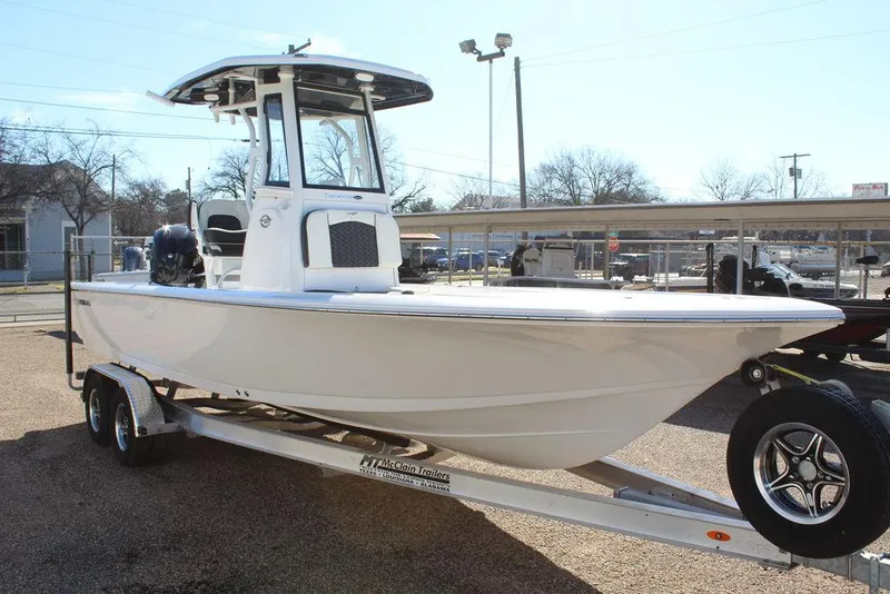 Slide: The Image of 2025 Tidewater 2410 BM boat on trailer, parked outdoors, side view. - 10