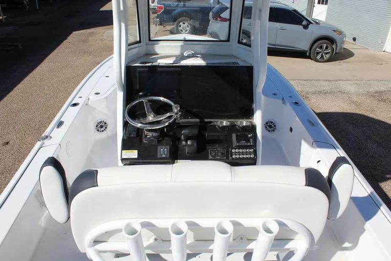 Slide: The Image of 2025 Tidewater 2410 BM boat interior with steering console and seating. - 12