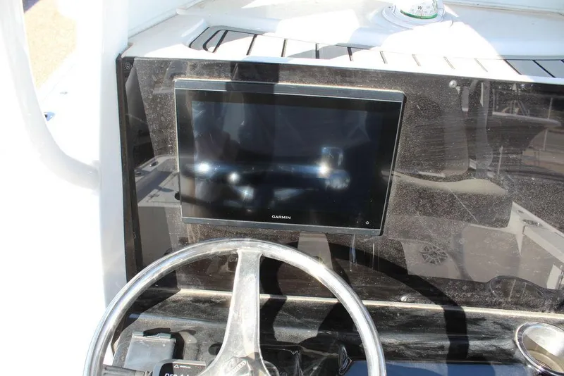 Slide: The Image of Steering console of 2025 Tidewater 2410 BM boat with Garmin display. - 15