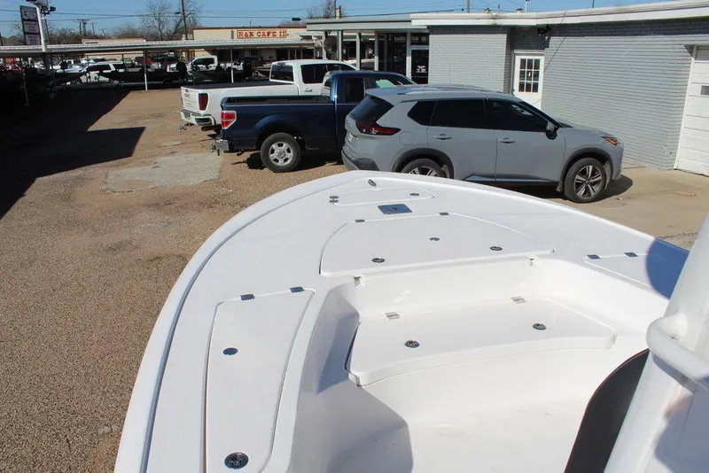 Slide: The Image of 2025 Tidewater 2410 BM boat in parking lot with cars in background. - 16