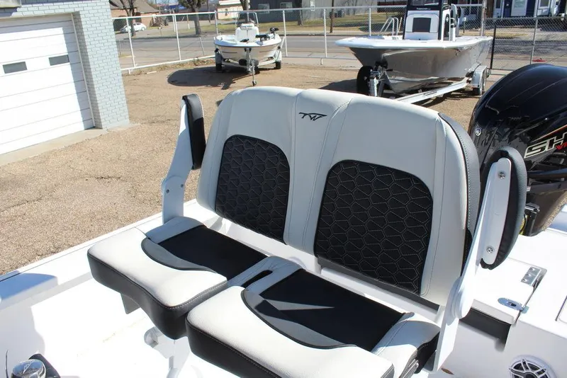 Slide: The Image of 2025 Tidewater 2410 BM boat seats with black and white upholstery, outdoor setting. - 22