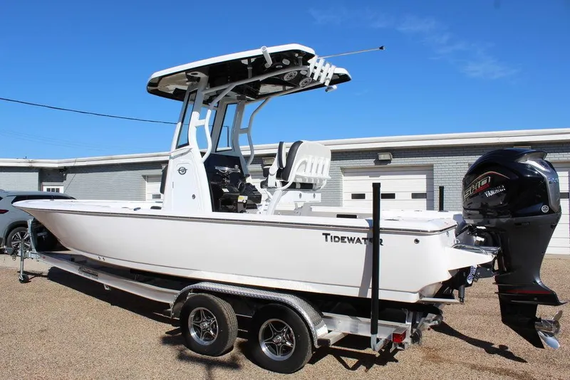 Slide: The Image of 2025 Tidewater 2410 BM boat on trailer, parked outdoors, featuring a sleek design and powerful engine. - 3