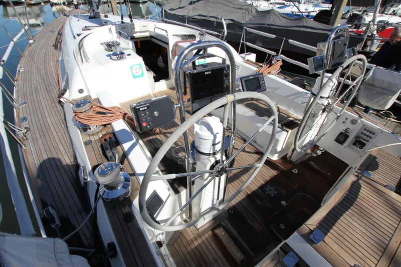 Slide: The Image of Nautor Swan 46mkIII yacht cockpit, 2006 model, featuring dual steering wheels and navigation equipment. - 10