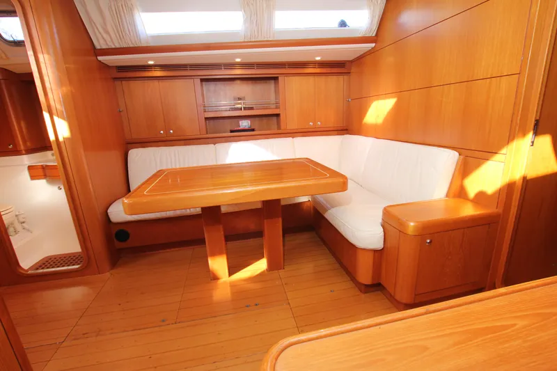 Slide: The Image of Interior of 2006 Nautor Swan 46mkIII yacht with wooden finish and white seating. - 12