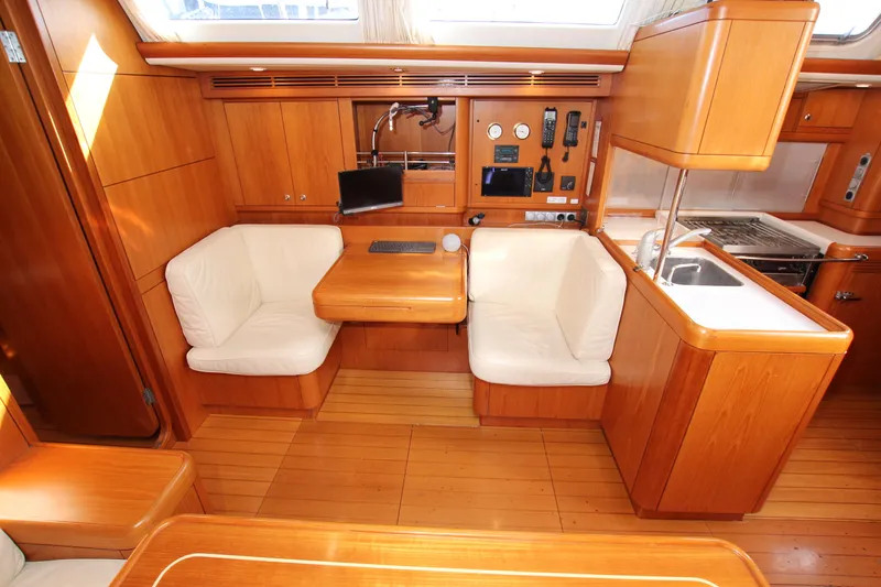 Slide: The Image of Interior of 2006 Nautor Swan 46mkIII yacht with wooden finish and white seating. - 13