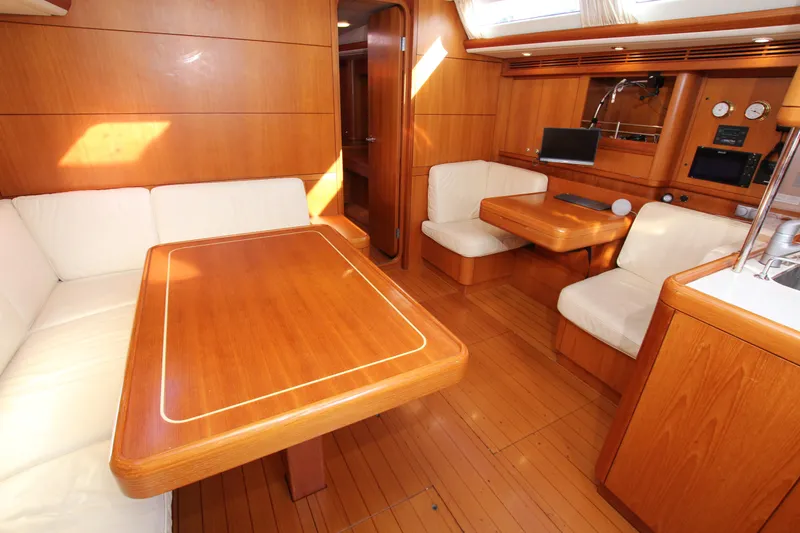 Slide: The Image of Interior of 2006 Nautor Swan 46mkIII yacht with wooden furnishings and white seating. - 14