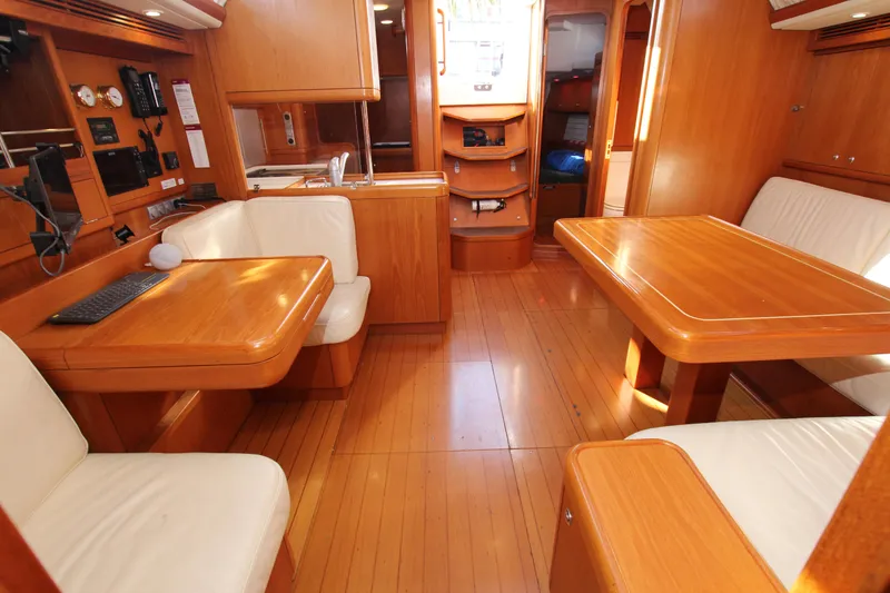 Slide: The Image of Interior of 2006 Nautor Swan 46mkIII yacht with wooden furnishings and white seating. - 18