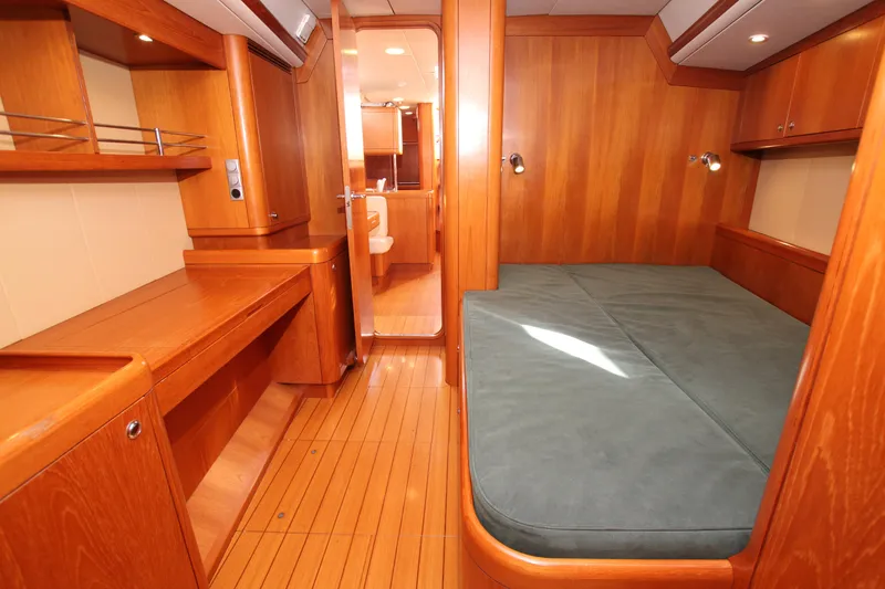 Slide: The Image of Interior of 2006 Nautor Swan 46mkIII yacht with wooden furnishings and cozy sleeping area. - 19