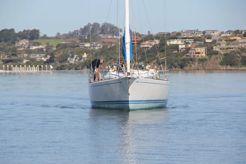 Slide: The Image of Sailing yacht Nautor Swan 46mkIII, 2006 model, cruising on calm waters near a coastal town. - 2