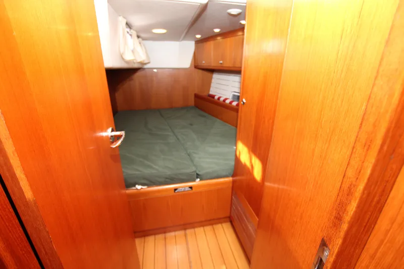 Slide: The Image of Nautor Swan 46mkIII 2006 cabin interior with wooden finish and cozy bed. - 21