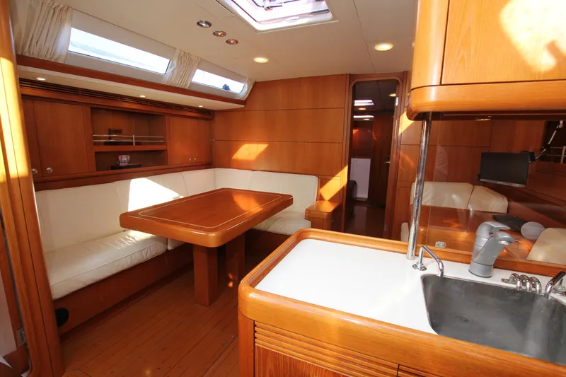 Slide: The Image of Luxurious interior of 2006 Nautor Swan 46mkIII yacht with wooden finishes and seating area. - 26