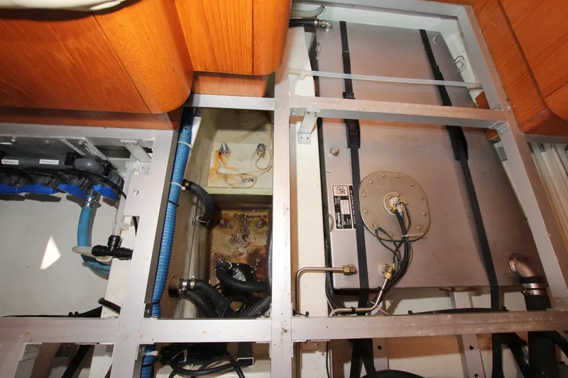 Slide: The Image of Engine compartment of 2006 Nautor Swan 46mkIII yacht, showcasing mechanical components and wiring. - 30