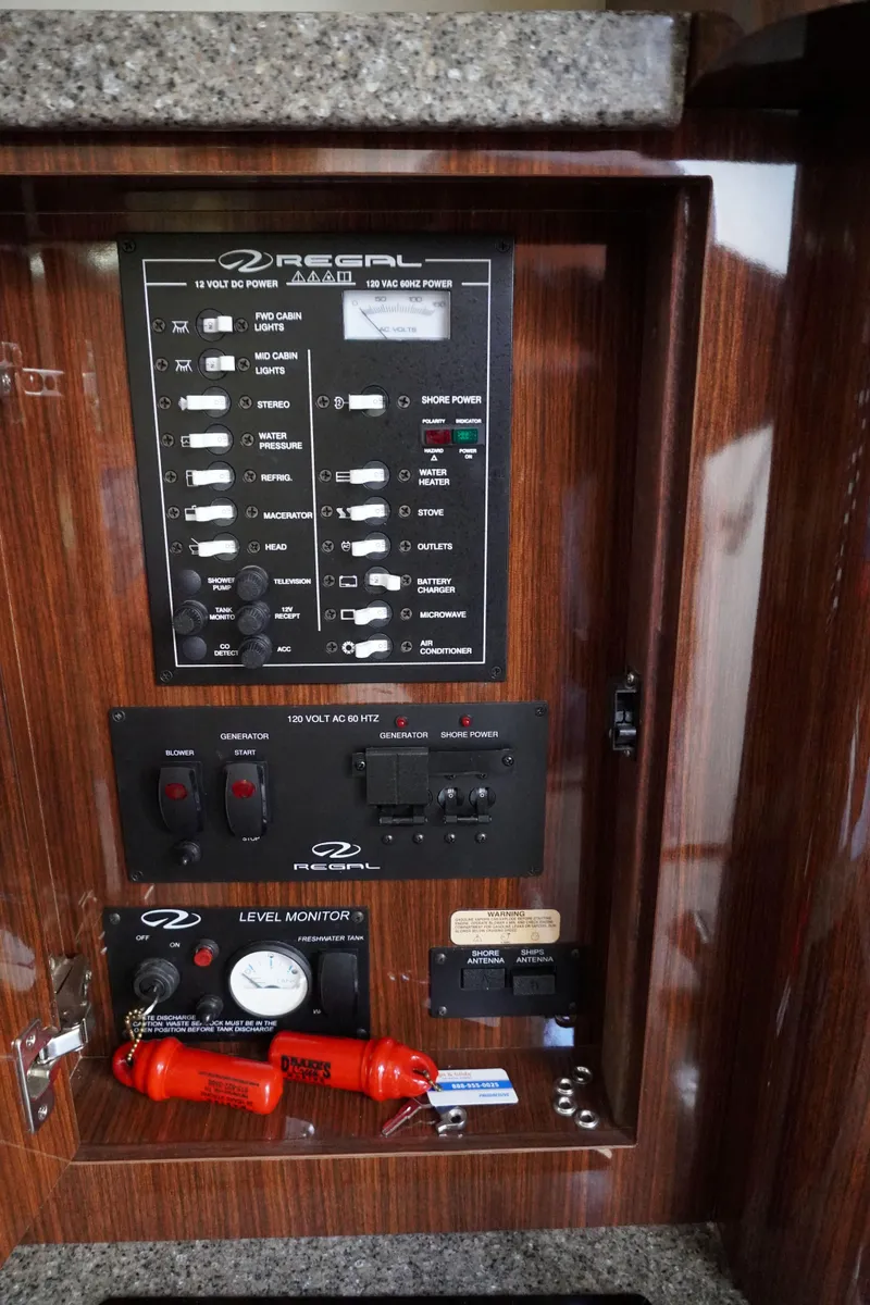 Slide: The Image of Control panel of a 2013 Regal 28 Express boat with switches and indicators. - 11