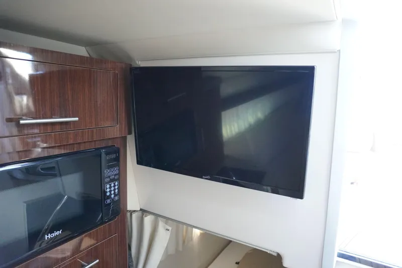 Slide: The Image of Interior of 2013 Regal 28 Express with TV and microwave. - 12