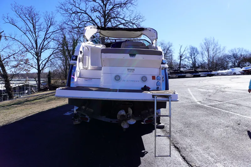 Slide: The Image of 2013 Regal 28 Express boat parked on asphalt, rear view with ladder. - 3