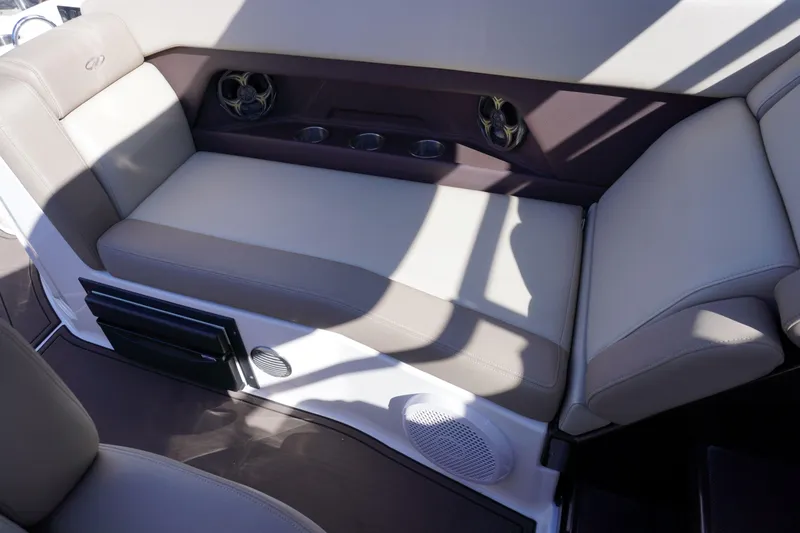 Slide: The Image of 2013 Regal 28 Express boat interior seating with speakers and cup holders. - 9