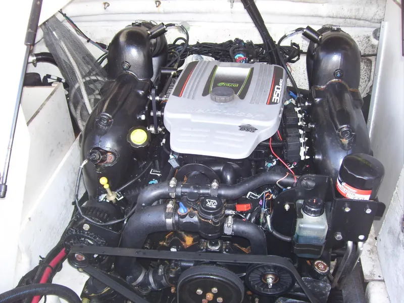 Slide: The Image of Engine of a 2015 Sea Ray 240 Sundeck boat, showcasing detailed components. - 12