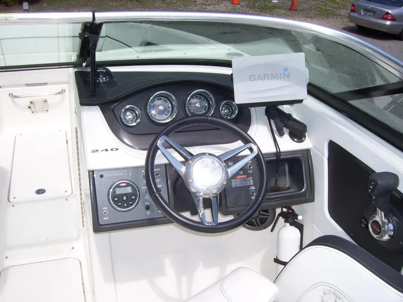 Slide: The Image of 2015 Sea Ray 240 Sundeck boat dashboard with Garmin navigation system. - 4