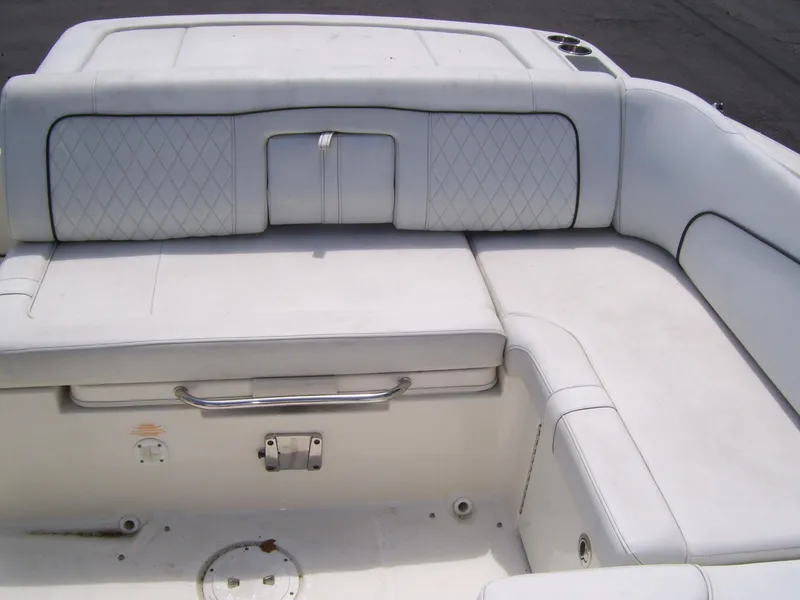 Slide: The Image of 2015 Sea Ray 240 Sundeck interior seating with white upholstery and diamond stitching. - 9