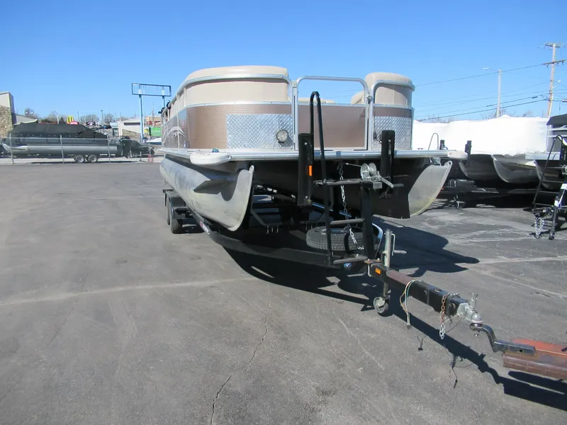 Slide: The Image of 2012 Starcraft Stardeck 226 Cruise N Fish pontoon boat on trailer in parking lot. - 1
