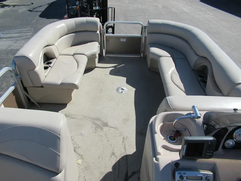 Slide: The Image of 2012 Starcraft Stardeck 226 Cruise N Fish boat interior with beige seating and control panel. - 4