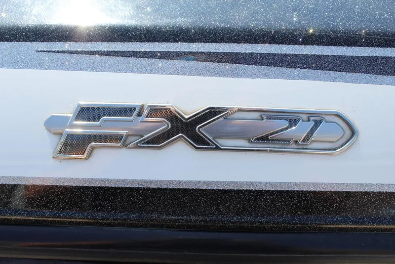 Slide: The Image of 2018 Skeeter FX21 LE emblem on a sleek, metallic surface. - 13