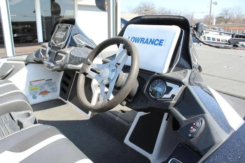 Slide: The Image of 2018 Skeeter FX21 LE boat cockpit with steering wheel and Lowrance display. - 15
