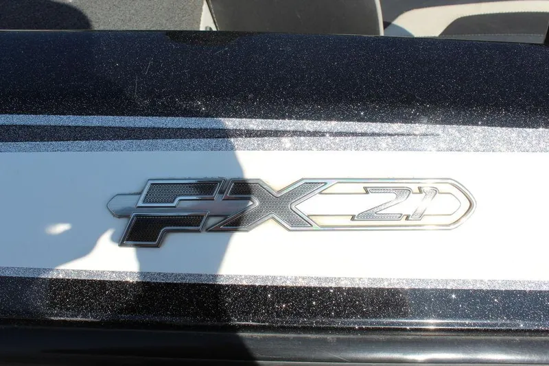 Slide: The Image of 2018 Skeeter FX21 LE boat logo on a sleek black and white surface. - 18