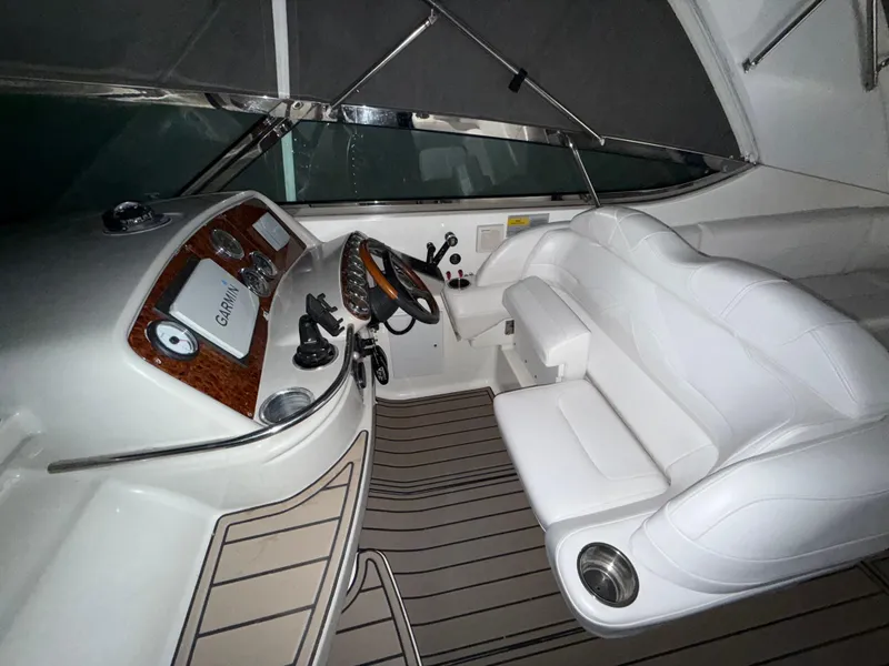 Slide: The Image of 2003 Formula 400ss boat interior with white seating and Garmin navigation system. - 11