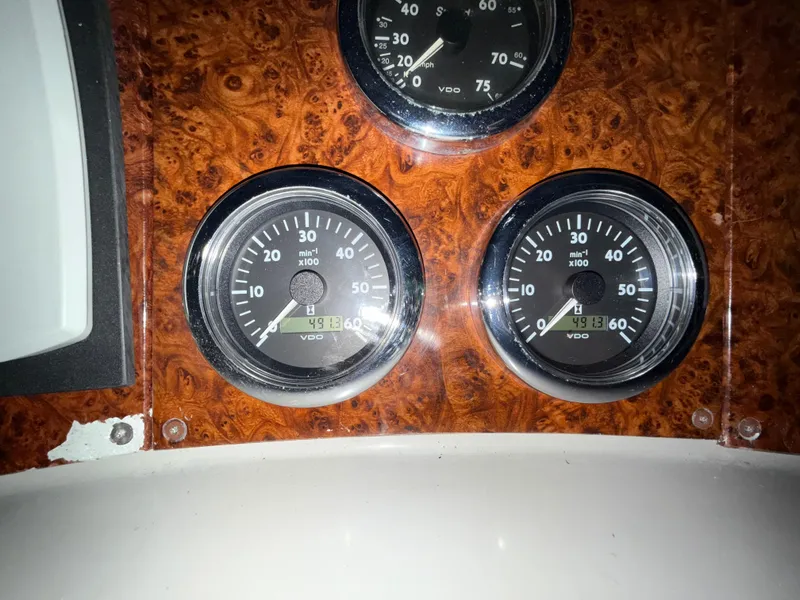 Slide: The Image of Dashboard gauges of a 2003 Formula 400ss boat, featuring wood paneling and VDO instruments. - 16