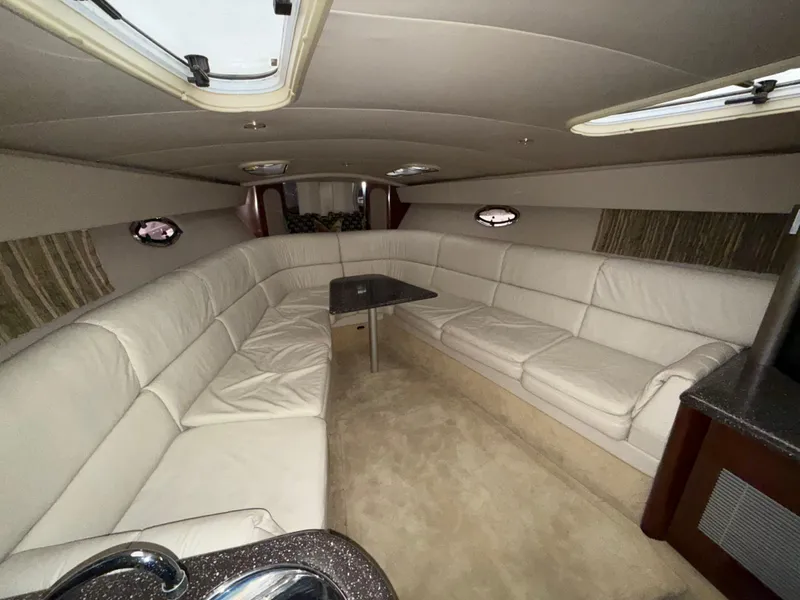 Slide: The Image of Interior of a 2003 Formula 400ss yacht with white leather seating and a small table. - 18