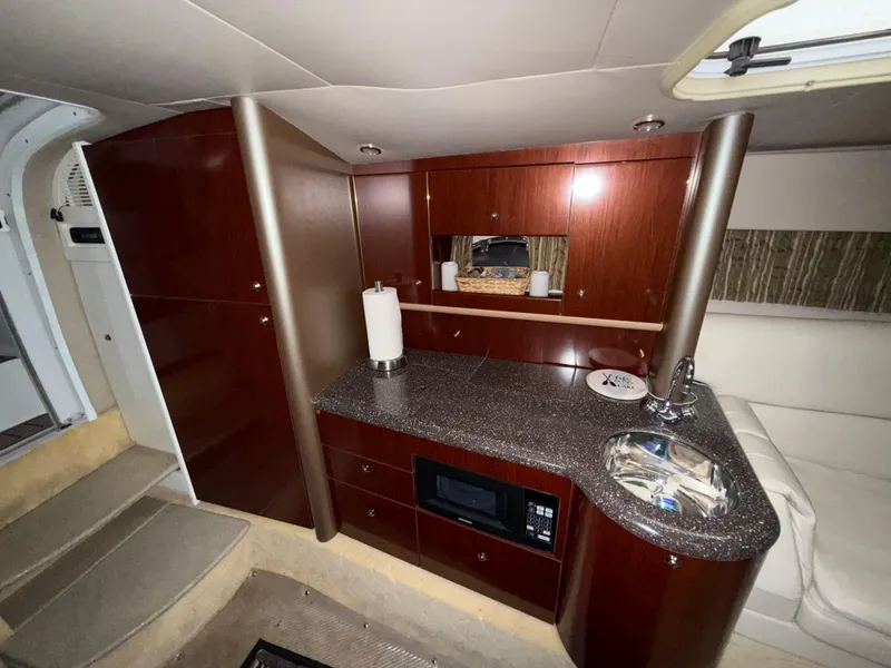 Slide: The Image of Interior of a 2003 Formula 400ss boat with kitchenette and seating area. - 21