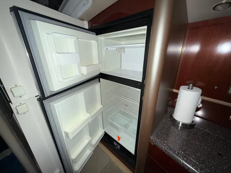 Slide: The Image of Open refrigerator in 2003 Formula 400ss boat interior, with paper towel holder on counter. - 22