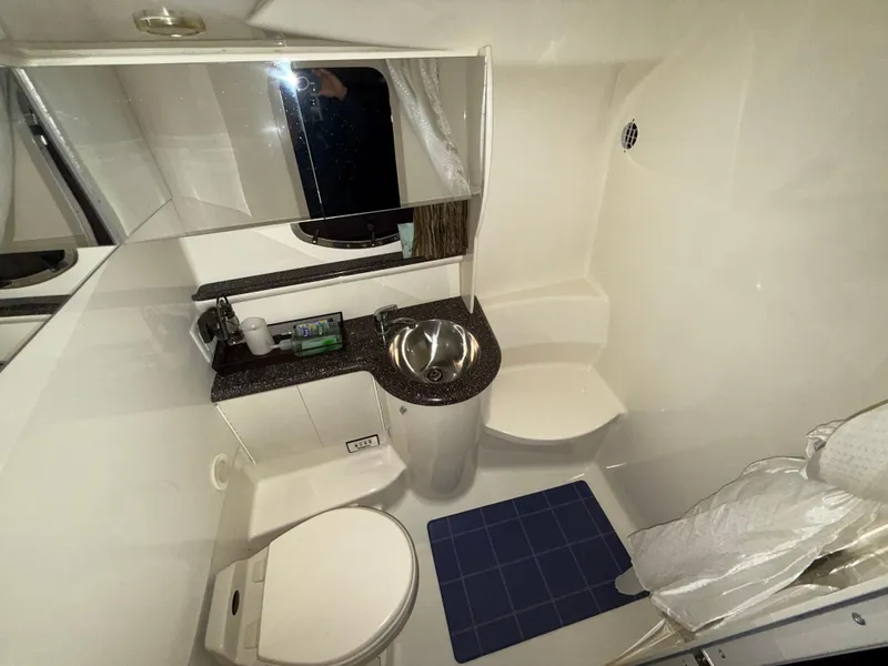 Slide: The Image of Compact bathroom in a 2003 Formula 400ss boat with sink, toilet, and mirror. - 23