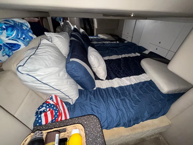 Slide: The Image of Cozy cabin interior of a 2003 Formula 400ss boat with blue bedding and pillows. - 25