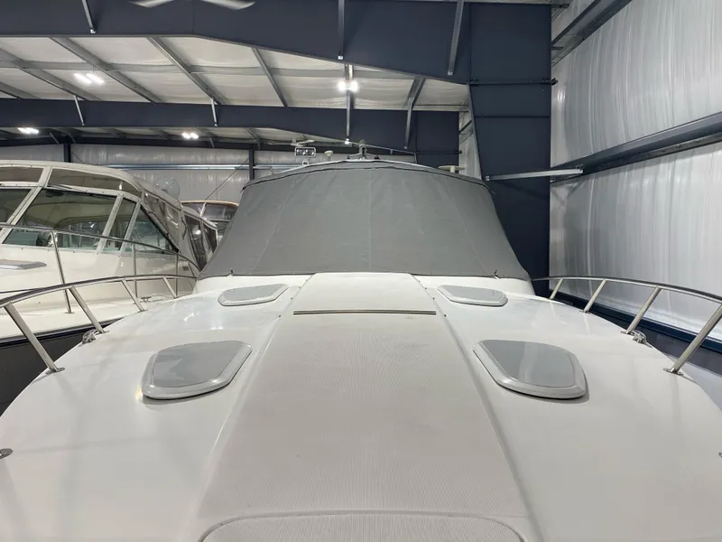 Slide: The Image of 2003 Formula 400ss boat in storage, covered and surrounded by other vessels. - 5