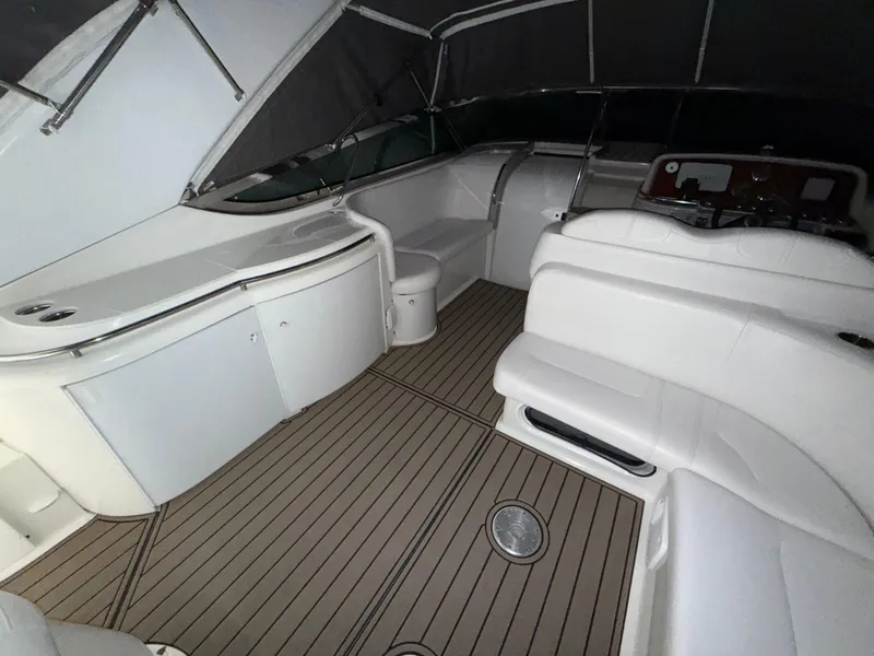Slide: The Image of 2003 Formula 400ss boat interior with white seating and wood-style flooring. - 8