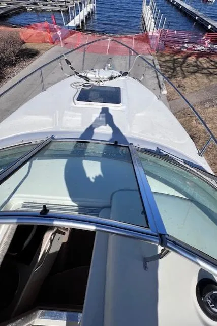 Slide: The Image of 2000 Sea Ray 245 Weekender boat docked, viewed from above with shadow on deck. - 10