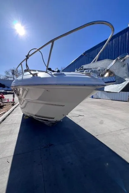 Slide: The Image of 2000 Sea Ray 245 Weekender boat docked under clear blue sky. - 14