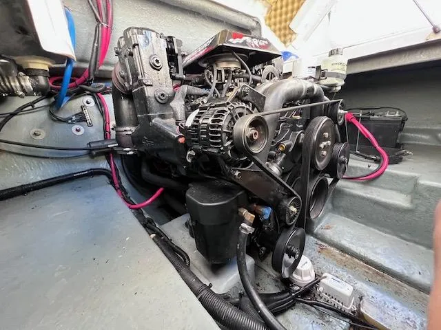 Slide: The Image of Engine compartment of a 2000 Sea Ray 245 Weekender boat, showcasing mechanical components. - 15