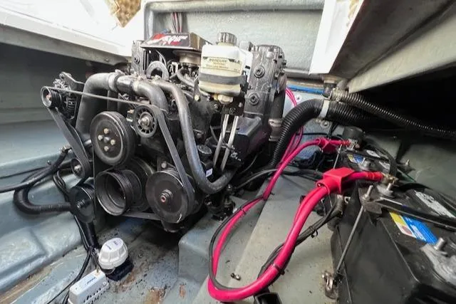 Slide: The Image of Engine compartment of a 2000 Sea Ray 245 Weekender boat, showing detailed mechanical components. - 16