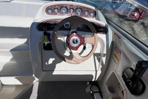 Slide: The Image of 2000 Sea Ray 245 Weekender dashboard with steering wheel and instrument panel. - 5