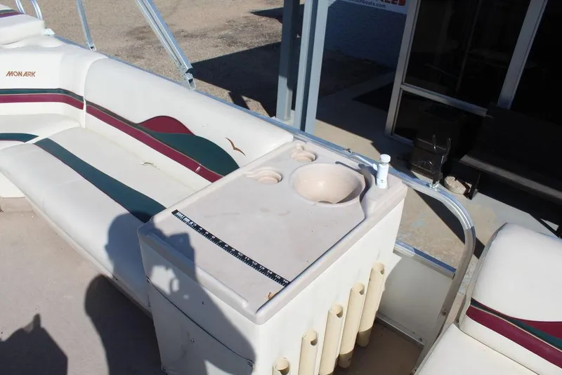 Slide: The Image of 1997 Monark Pontoon boat interior with seating and built-in sink. - 11
