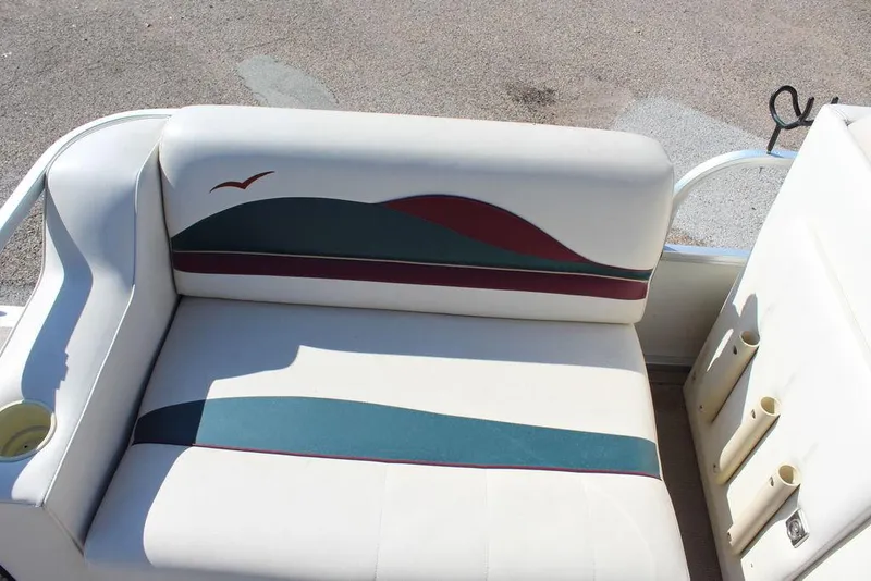 Slide: The Image of 1997 Monark Pontoon boat seat with colorful wave design and cup holder. - 13