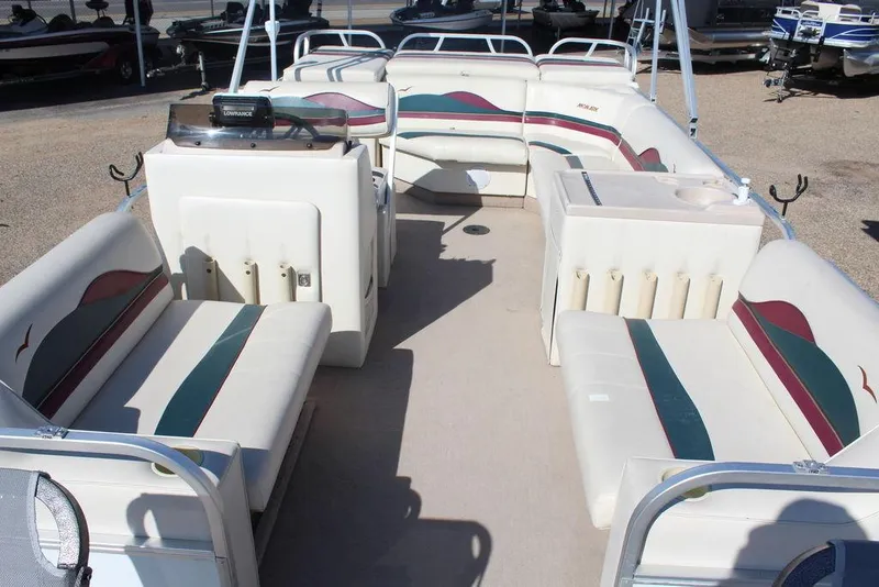 Slide: The Image of 1997 Monark Pontoon boat interior with spacious seating and helm, ideal for leisure activities. - 8