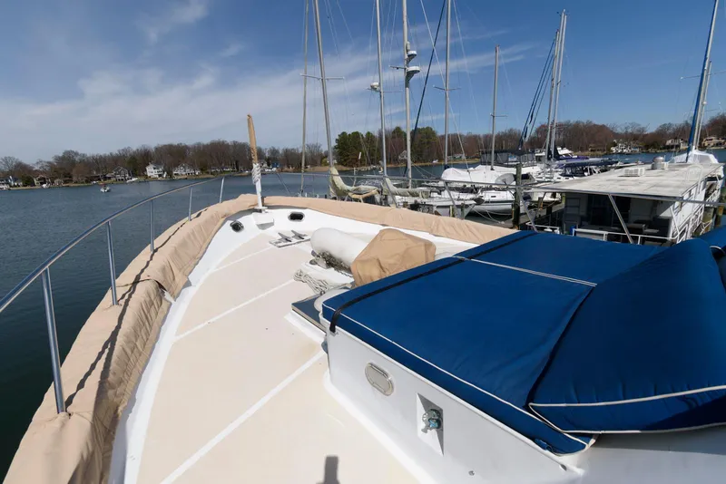 Slide: The Image of Broward 100 yacht from 1984 docked at a marina, featuring a spacious deck. - 25