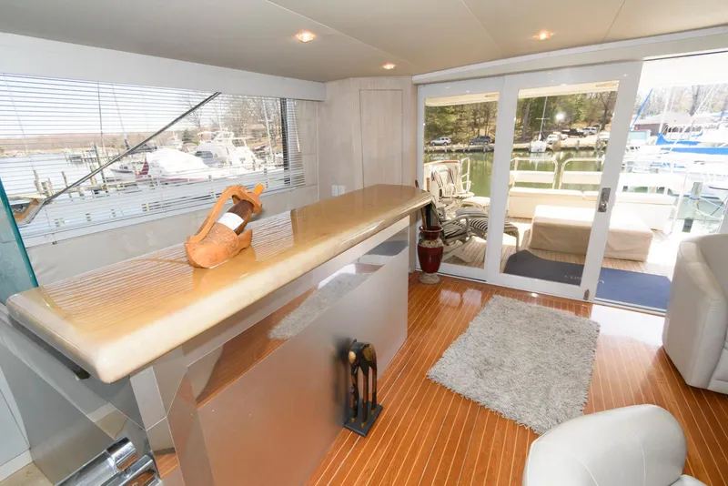 Slide: The Image of Luxurious interior of 1984 Broward 100 yacht with modern bar and outdoor view. - 29