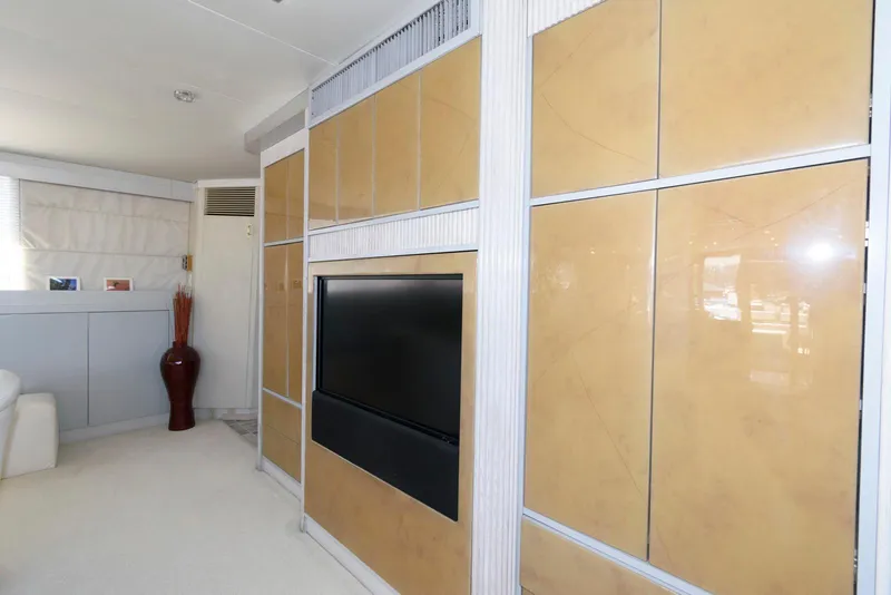 Slide: The Image of Luxurious interior of 1984 Broward 100 yacht with modern wood paneling and flat-screen TV. - 34